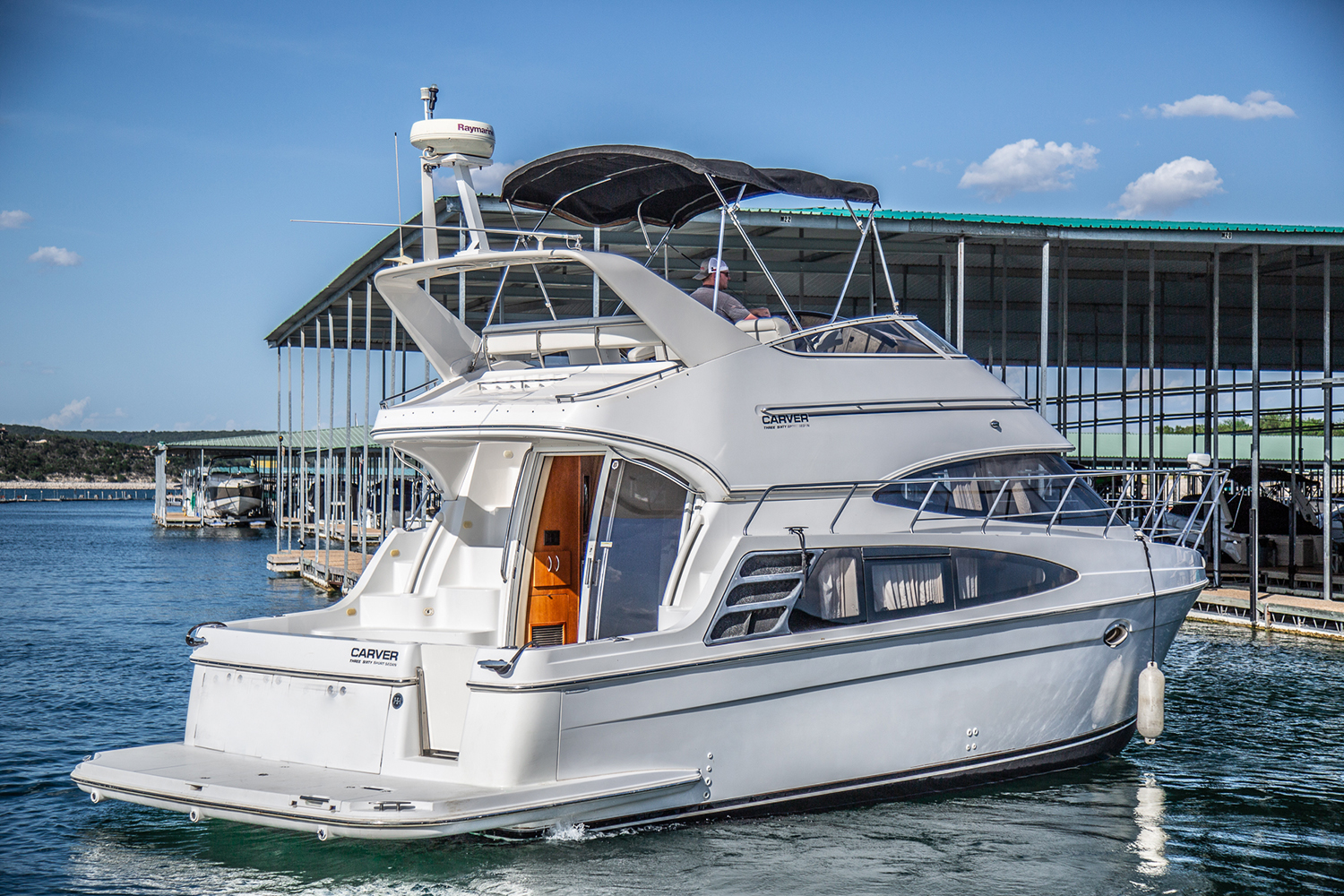 Lake Travis Yacht Rental's Carver 360 Sport Sedan “Moonraker” pulling out of the slip.