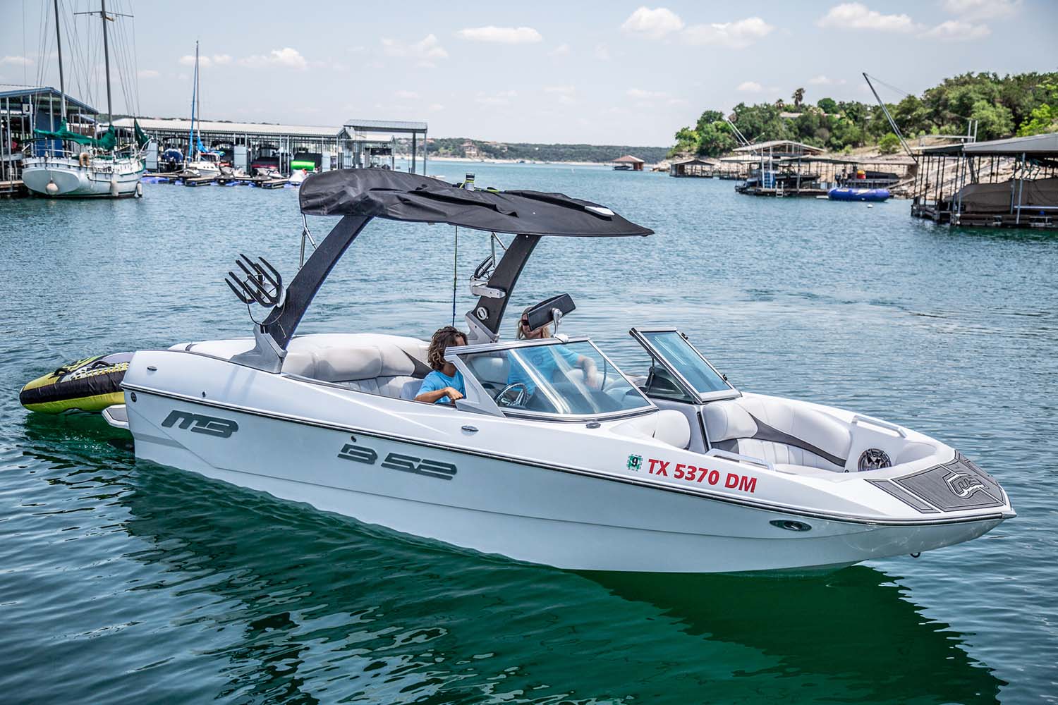 Lakeway Marina Wake Boat rentals come with a driver and toys.