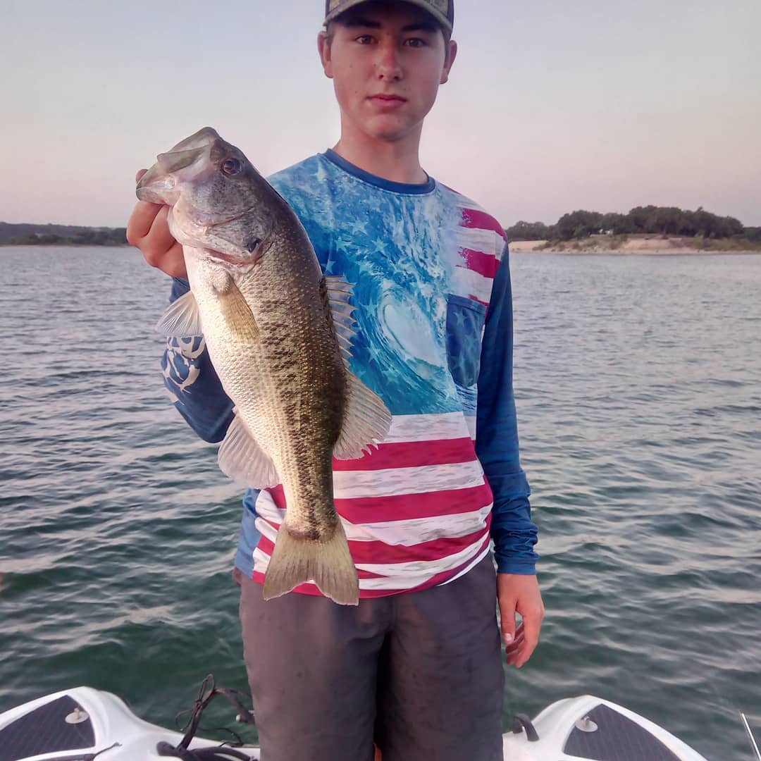 Tanner Shelton boats one on Lake Travis with Bushwhacker Bait Co guide Kleigh Westphall
