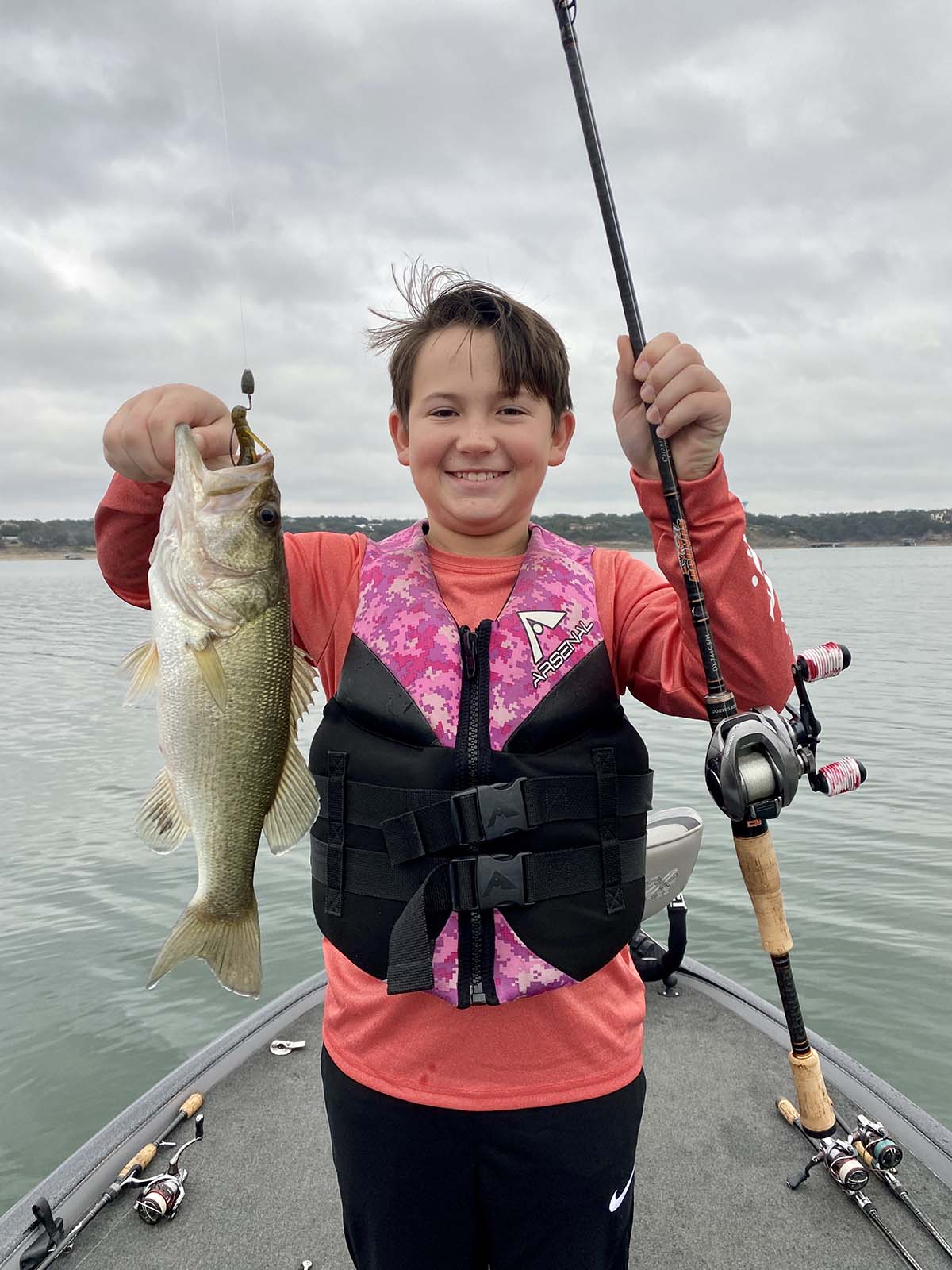 Black little girl holding fishing rod and enjoying time with